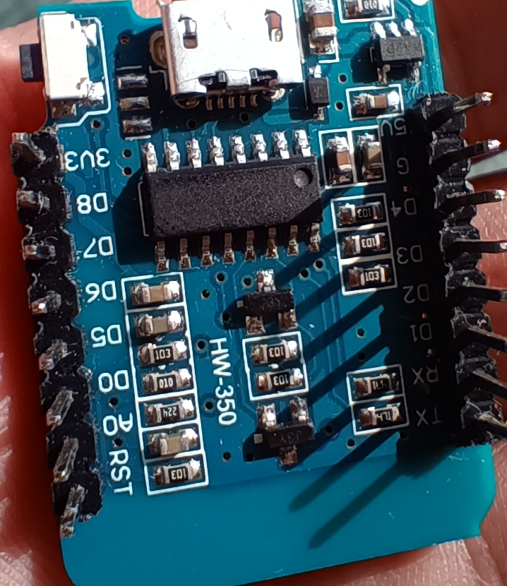 The Wemos D1 Mini board backside that shows the USB-to-UART chip with no name
